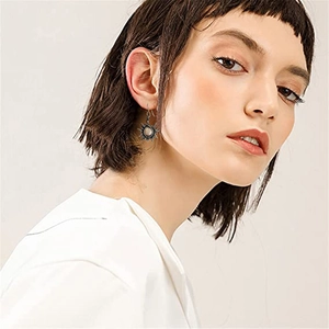 Boucles d'oreilles soleil bohèmes avec pierre de lune en argent vieilli sur modèle