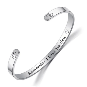 Macro view of engraved 'Remember I Love You Son' on stainless steel cuff bracelet