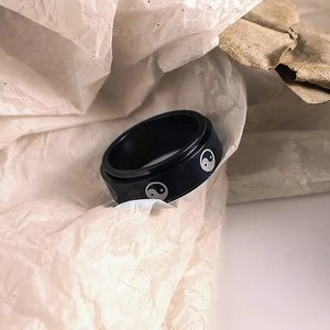 Close-up of 8mm black stainless steel spinning ring with white Tai Chi pattern