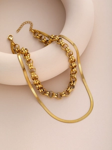 Close-up of double-layer gold snake chain necklace with lobster clasp and extender