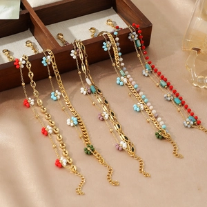 Detailed display of colorful floral pendants on gold plated bohemian style necklaces