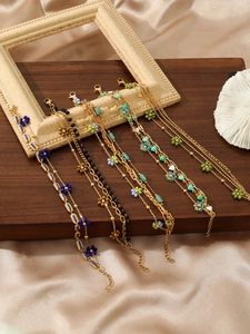 Detail of five bohemian floral bracelets with colorful beads and gold plated lobster clasps