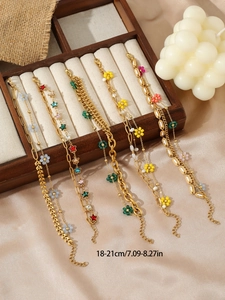 Detail view of five gold bracelets with enamel flowers and colorful star charms set
