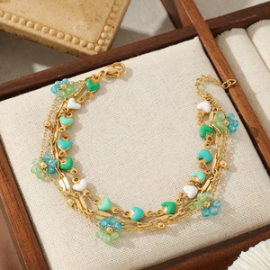 Layered gold stainless steel bracelet with colorful heart charms and flower beads