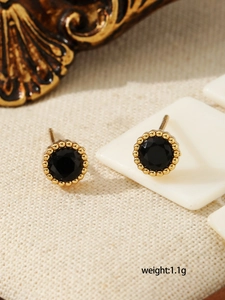 Close-up of vintage round black zircon earrings with gold beaded edges and 1.1g weight