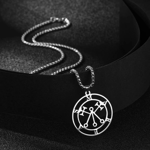 Macro shot of silver Marbas sigil necklace with engraved occult symbol pendant