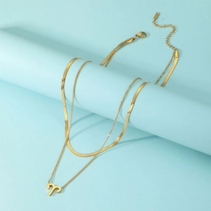 Detail of gold-plated stainless steel double-layer necklace with Aries zodiac pendant