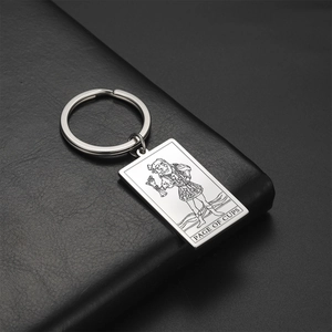 Macro view of Page of Cups tarot card pendant with polished silver stainless steel finish