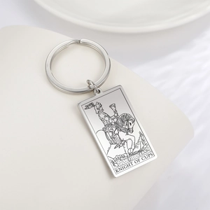 Macro shot of Knight of Cups tarot card laser engraving on a steel keychain pendant