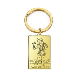 Macro detail of Page of Cups tarot card design on polished golden stainless steel keychain