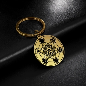 Detail view of Metatron's Cube engraved on a golden stainless steel keychain charm