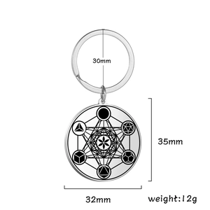 Silver stainless steel keychain with geometric Metatron cube pendant on white background