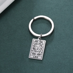 Detail view of a stainless steel keychain with a laser-engraved Leo zodiac rectangular tag