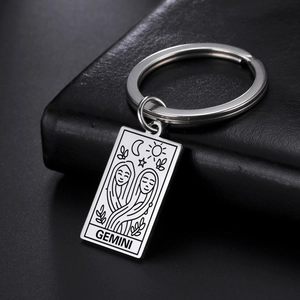 Macro shot of laser engraved Gemini tarot stainless steel rectangular keychain pendant