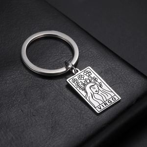 Macro shot of silver stainless steel keychain featuring an engraved Virgo sign square pendant