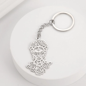 Detail of laser-cut stainless steel Frida Kahlo keychain with rose headpiece and key ring