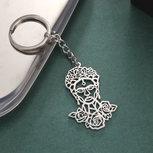 Detail of stainless steel keychain featuring a hollow-out Frida Kahlo floral rose design