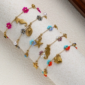 Golden ocean theme charm bracelets with multi-color flower beads and sea life pendants