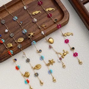 Gold ocean themed charm bracelet set with seahorse starfish pendants and colorful beads