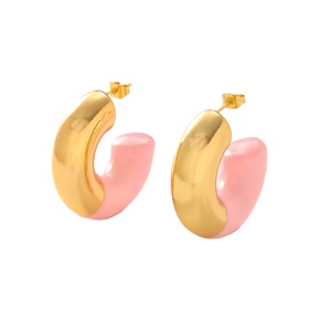 Detailed view of C-shaped hoop earrings featuring polished gold and pink enamel finish