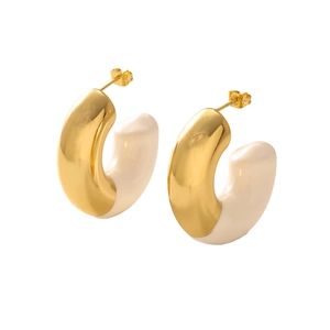 Detailed macro view of two-tone C-shaped hoop earrings in gold and cream enamel