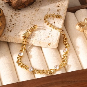 Detail of titanium steel garnet bracelet featuring gold-plated chain and zircon settings