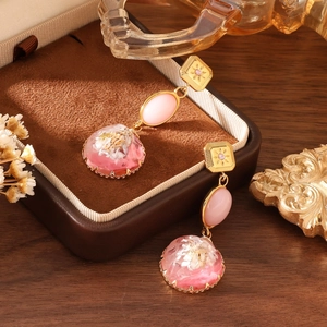 Vintage floral drop earrings with white dried flowers and pink gemstones on velvet box