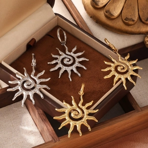 Titanium steel sun pendant earrings with 18k gold plating and textured sunburst design