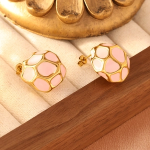 Detailed macro view of vintage geometric stainless steel earrings with pink enamel finish