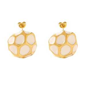 Detail of gold hollow geometric stud earrings with white enamel inlay for women