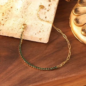 Vue détaillée du bracelet doré avec pierres de zircon vert foncé et fermoir mousqueton