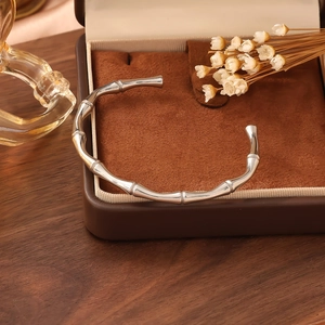 Detailed close-up of a silver bamboo joint cuff bracelet in a vintage jewelry gift box