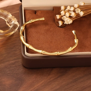 Detail of 18K gold plated bamboo ridge cuff bracelet on elegant velvet jewelry box