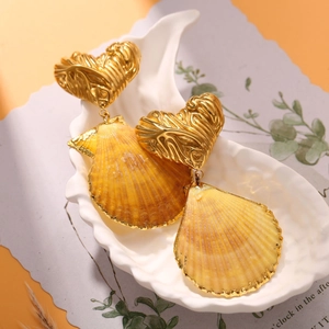 Golden heart seashell earrings with orange gradient shells and detailed metal trim