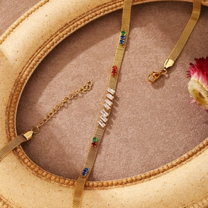 Elegant 18k rose gold mesh necklace with multicolor baguette gems and goodluck charm