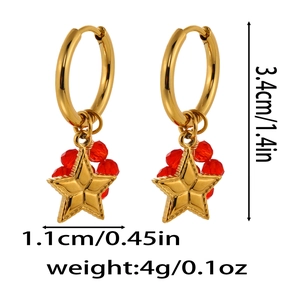 Detail view of gold star dangle earrings with red faceted beads and size measurements