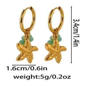 Detail view of gold starfish drop earrings with green beads and product dimensions