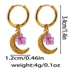 Detail of Saturn-themed earrings with purple beaded flower and hammered moon pendant