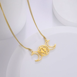 Detail of 18k gold plated stainless steel necklace with triple moon and star pendant