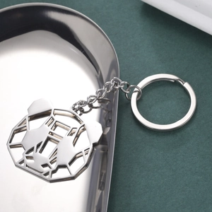 Detail shot of hollow geometric panda pendant keychain made of polished stainless steel