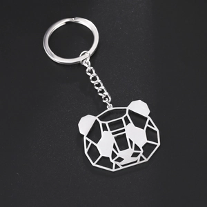 Cute hollow-out panda pendant keychain made of polished stainless steel on black background