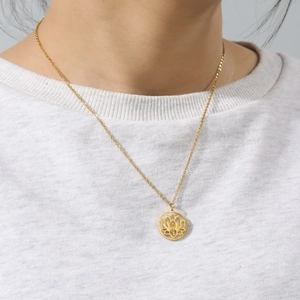 Detailopname van een minimalistische gouden roestvrijstalen ketting met lotusbloem hanger
