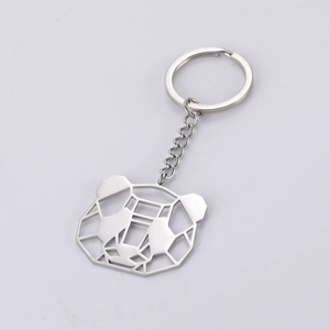 Macro detail of the silver geometric hollow panda keychain made of durable stainless steel