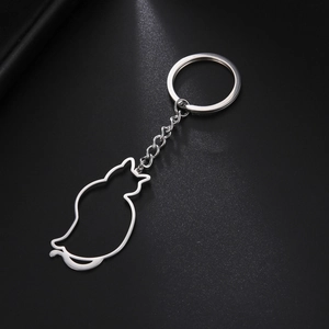 Polished 304 stainless steel keychain with a minimalist hollow cat pendant on black texture