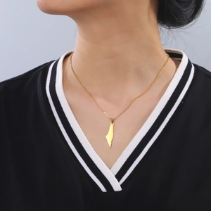 Unisex gold stainless steel necklace with geometric mountain map pendant on a model