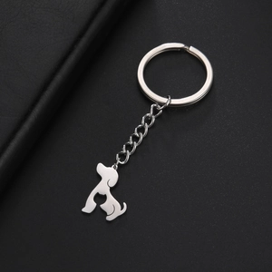 Macro shot of polished stainless steel keychain featuring a hollow dog and cat silhouette
