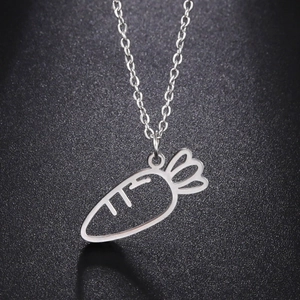 Close-up of a silver hollow carrot pendant necklace on a textured black background
