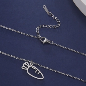 Close-up of hollow carrot pendant on stainless steel necklace with adjustable lobster clasp