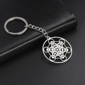 Stainless steel archangel keychain with Metatron geometric pendant on black leather background