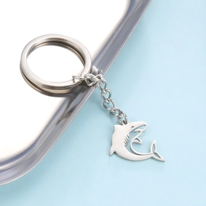 Detailed view of polished stainless steel shark pendant keychain with metal ring